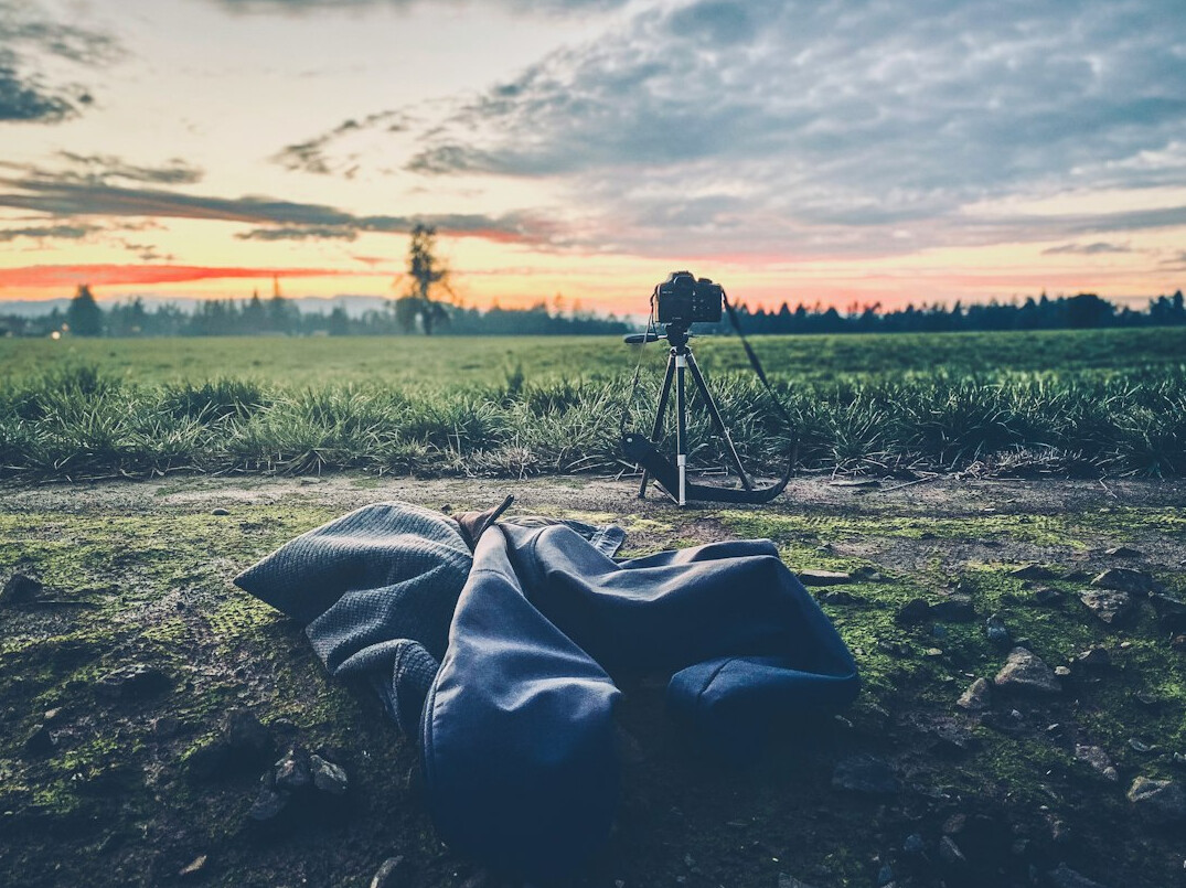 Journalist transmitting live video footage from a laptop in the field